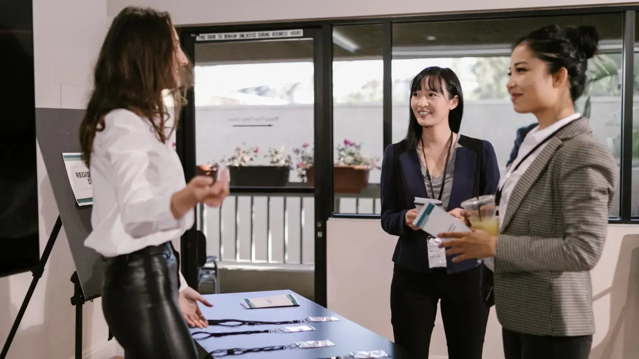 People queuing at a conference registration desk