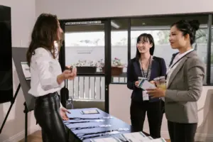 People queuing at a conference registration desk