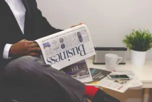 Business magazines and a laptop on a cafe table